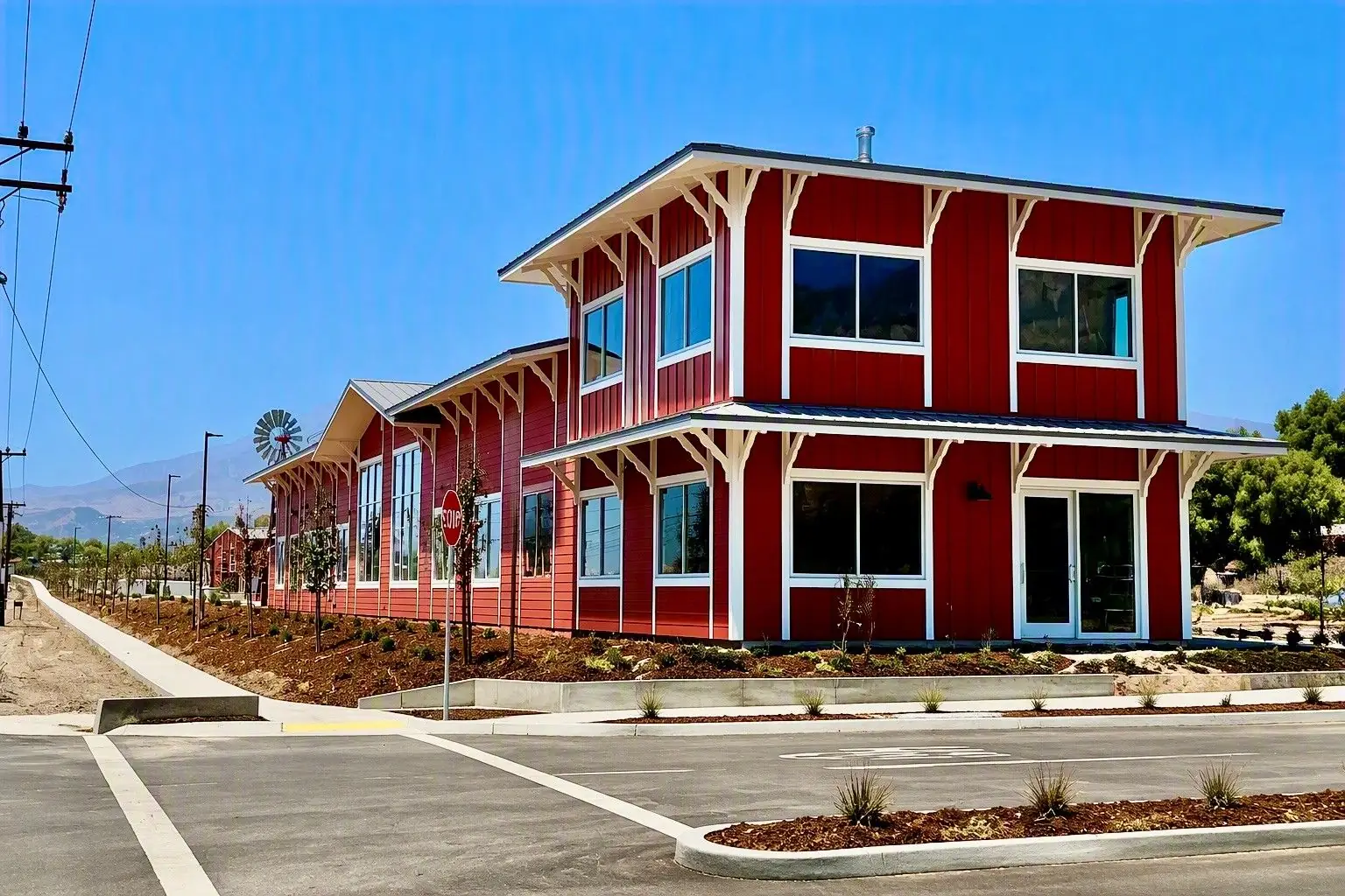 Red board-and-batten Highway 126 RV office building at the lot entrance on Highway 126 in Fillmore, CA