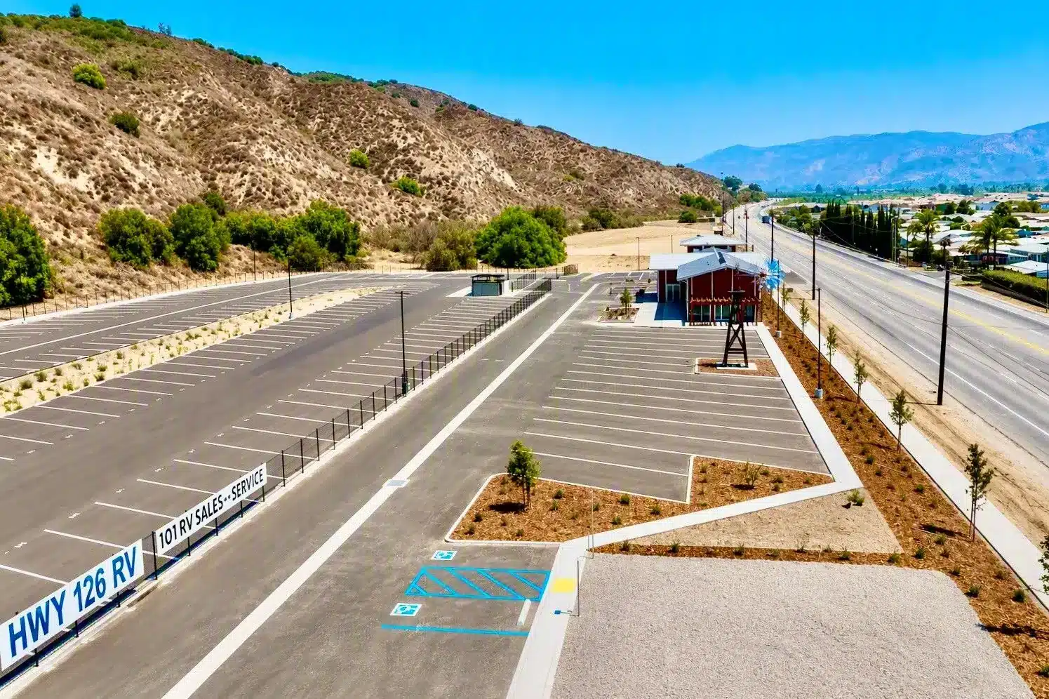 HWY 126 RV and 101 RV Sales–Service signs at the fenced entrance to the RV storage lot in Fillmore, CA